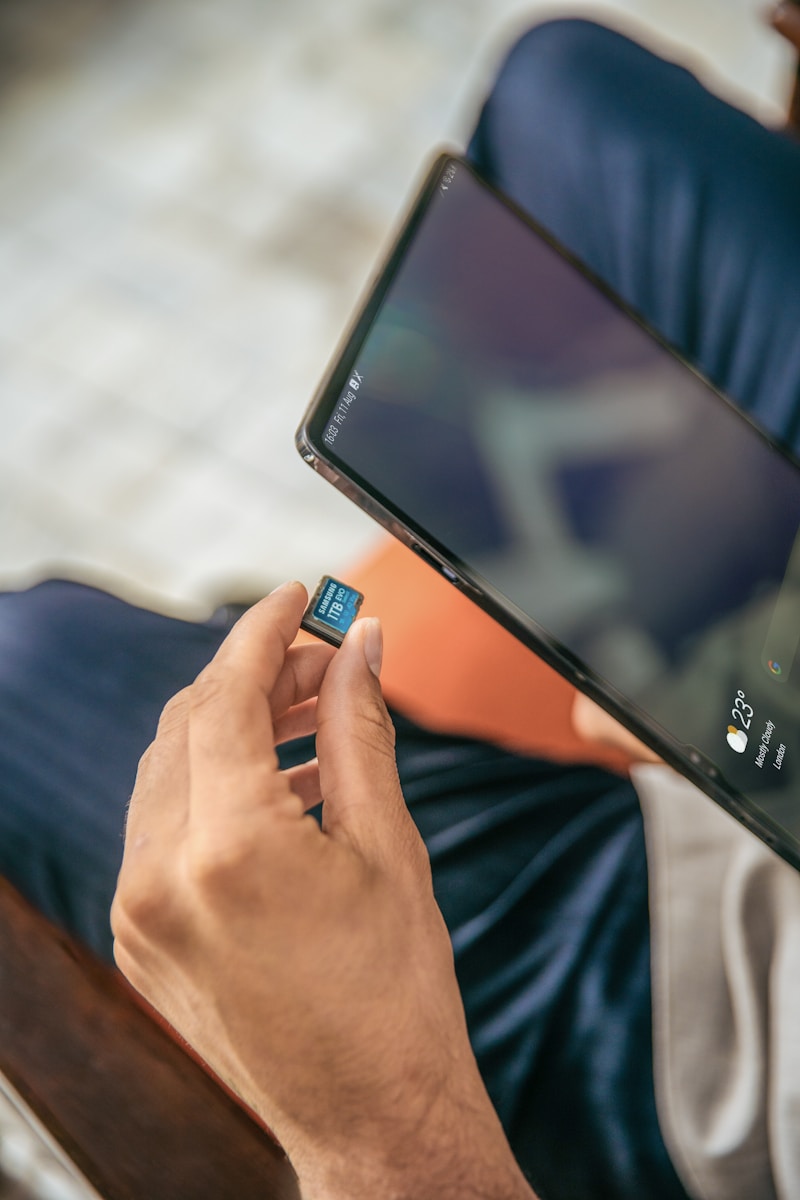 A man sitting on a chair holding a cell phone