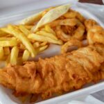 cooked meat and French fries in white disposable plate